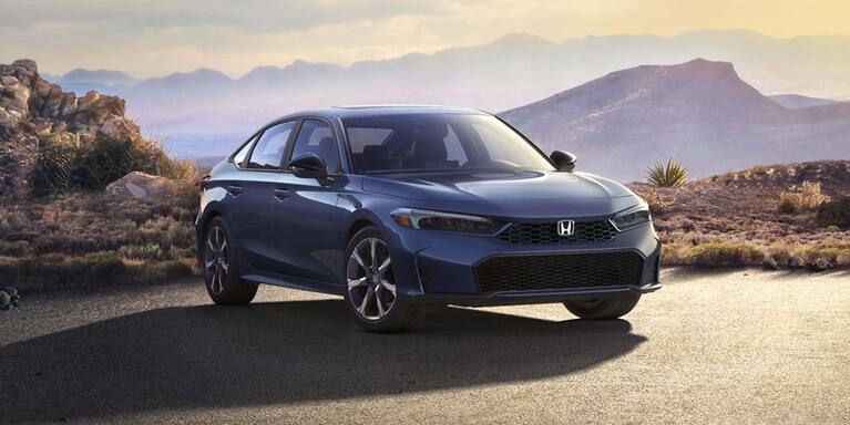 2027 Honda Civic Sedan Sport Touring Hybrid in Blue Lagoon Pearl front three-quarter view on a desert road (Compact Sedan)